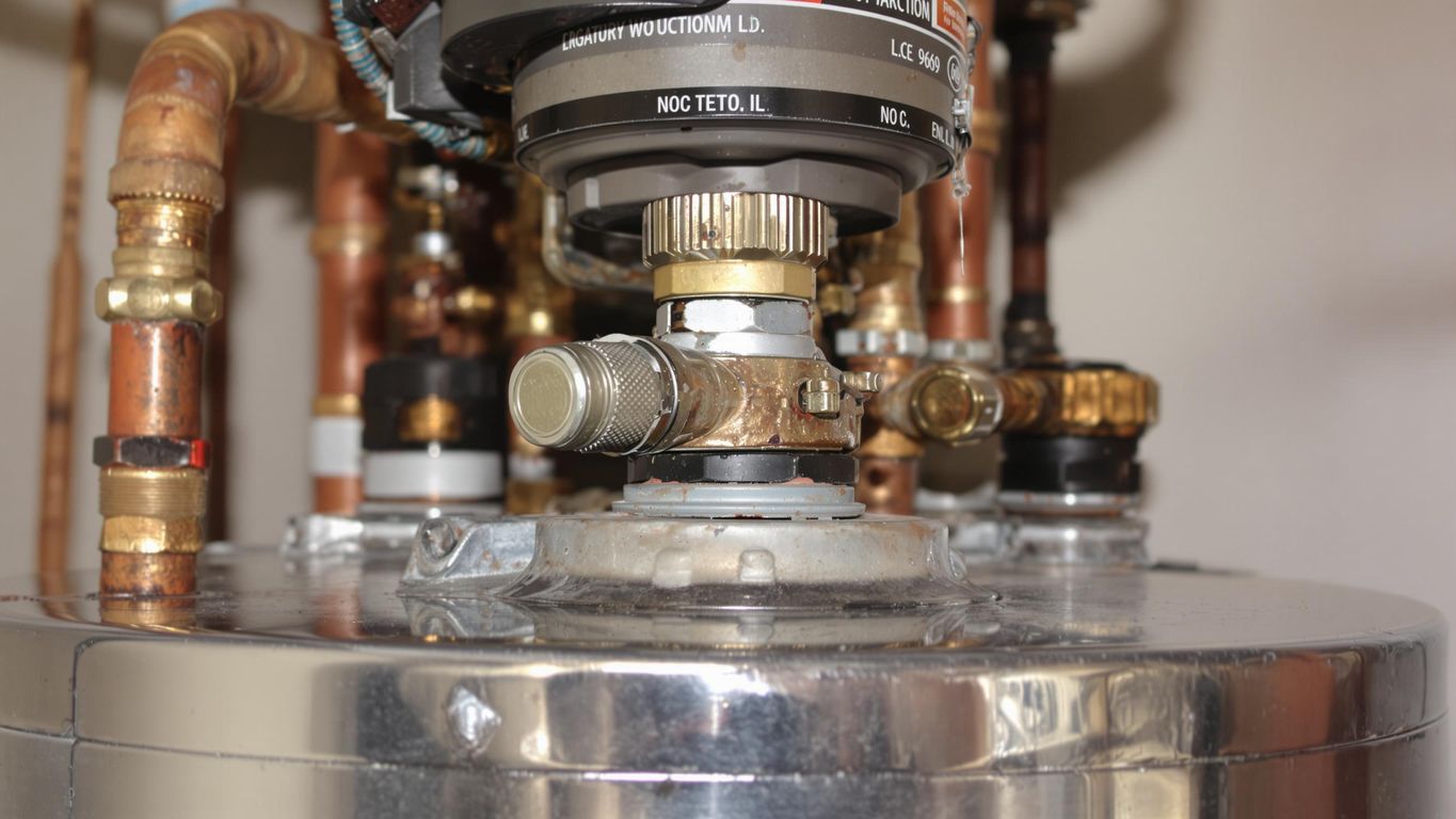 Close-up of a water heater with pipes and valves.