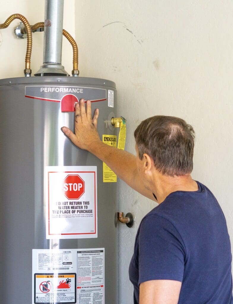 man checks a newly installed water heater