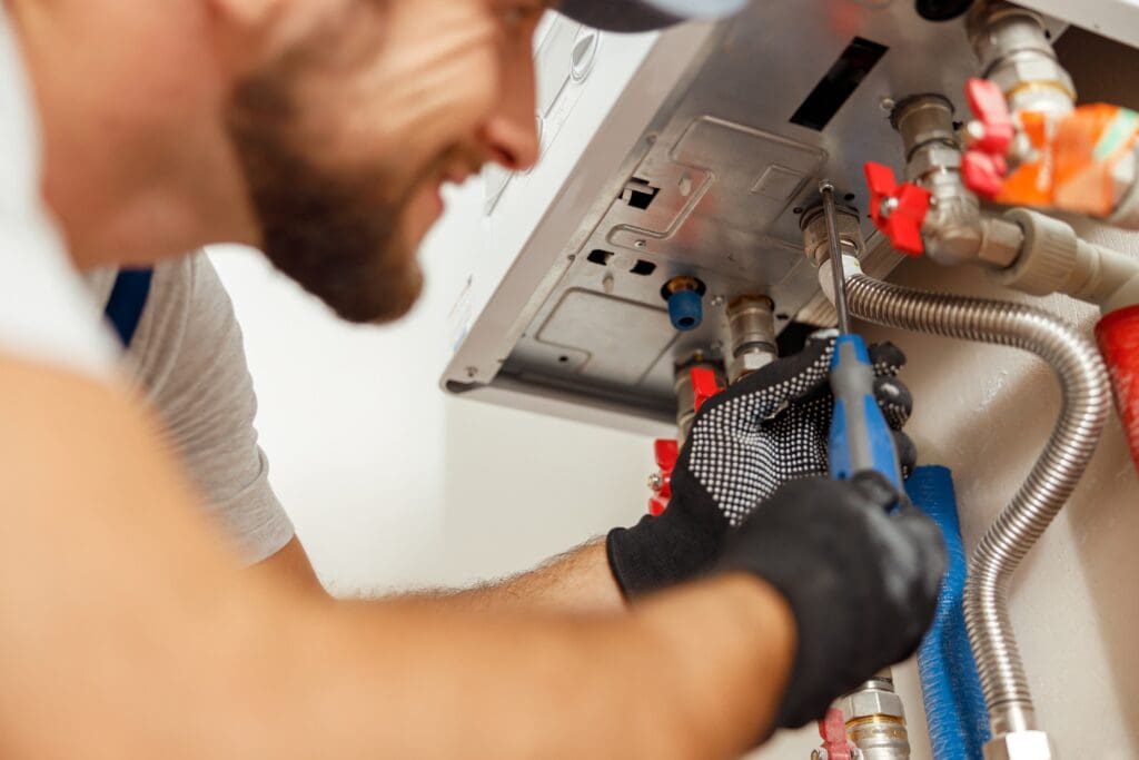 Plumber repairing a tankless water heater